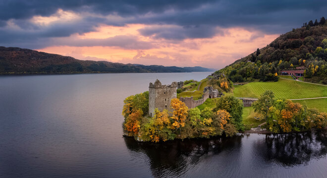 Aerial view of the impressive Urquhart Castle at the Loch Ness during autumn sunset time, Scotland