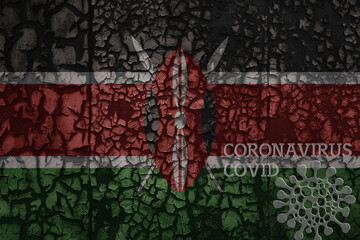 flag of kenya on a old metal rusty cracked wall with text coronavirus, covid, and virus picture.