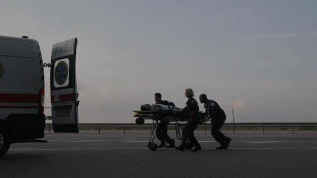 Ems paramedics in hurry transporting patient on stretcher