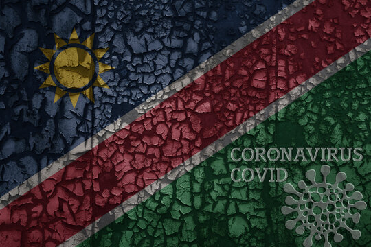 flag of namibia on a old metal rusty cracked wall with text coronavirus, covid, and virus picture.