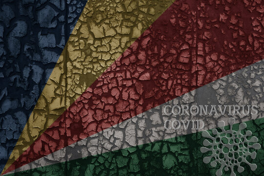 flag of seychelles on a old metal rusty cracked wall with text coronavirus, covid, and virus picture.