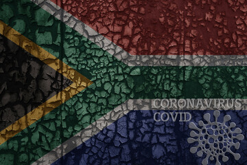 flag of south africa on a old metal rusty cracked wall with text coronavirus, covid, and virus picture.