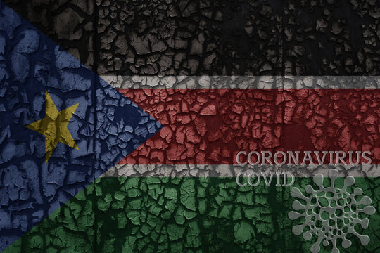 flag of south sudan on a old metal rusty cracked wall with text coronavirus, covid, and virus picture.