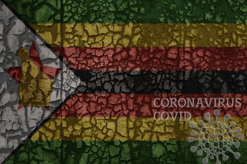 flag of zimbabwe on a old metal rusty cracked wall with text coronavirus, covid, and virus picture.