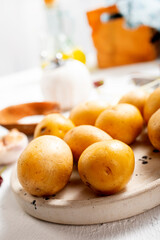 Naklejka na ściany i meble Peeled potatoes for cooking, raw potato on a table