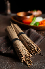 Uncooked soba and udon noodles. Traditional Japanese noodles on wooden table.