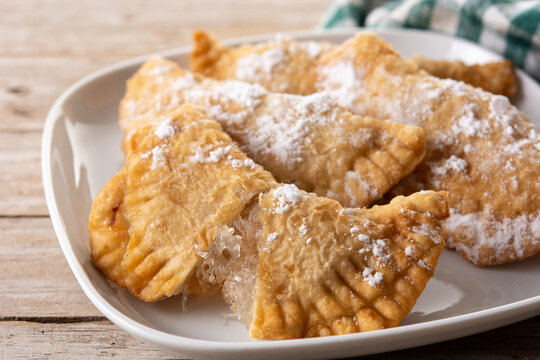 Spanish sweet stuffed pastry filled with angel hair on wooden table