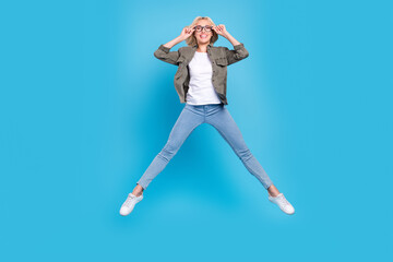 Fototapeta na wymiar Full length body size photo woman wearing glasses jumping up happy isolated pastel blue color background