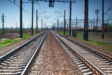 Fototapeta na wymiar Railroad tracks vanishing into the distance. Industrial landscape.
