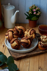 Cinnamon rolls, round yeast buns. Side view, wooden background.