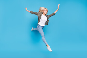 Obraz premium Full length body size photo happy woman jumping up careless running isolated pastel blue color background