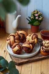 Cinnamon rolls, round yeast buns. Side view, wooden background.