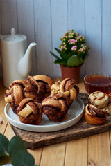 Cinnamon rolls, round yeast buns. Side view, wooden background.