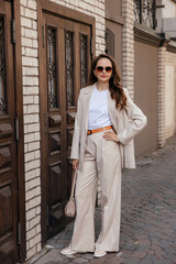 young woman in white pantsuit and white t-shirt