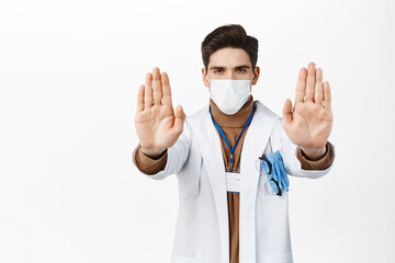 Image of male healthcare worker showing no gesture, stretching out hands in prohibit, warning...