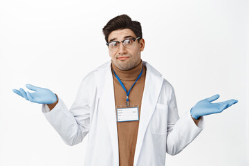 I dont know. Clueless male doctor shrugging shoulders, looking puzzled, have no idea, standing...