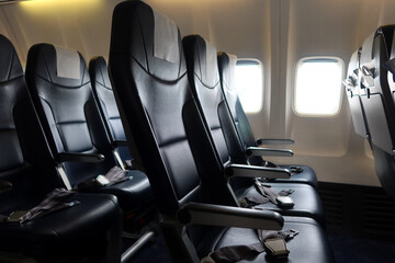 Passenger plane interior details. Empty seats with safety belts. A moment before passengers board