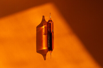 Magnesium capsules on an orange background. Drinking magnesium capsules. Solid background and capsules.  - obrazy, fototapety, plakaty