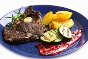 Beef Steak and vegetables on a plate. Delicious and healthy food. Isolate. Photo