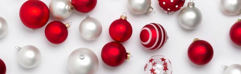 Red and white matte Christmas baubles decoration on white background