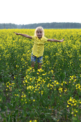 Fototapeta premium little girl in yellow field