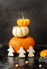 Halloween cookies - ghosts and bat with pumpkins on the black background