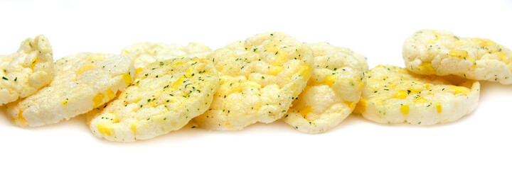 Closeup of crunchy Rice and Corn Snacks isolated on white background in panorama format