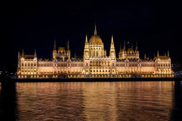 Fototapeta na wymiar view of the facade of the building of the parliament of budapest hungary at sunset at night with lights on the banks of the Danube river