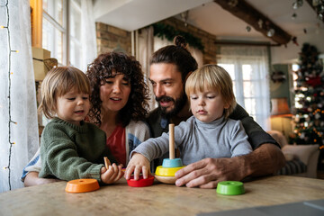 Happy family having fun time at home, parents playing with children.