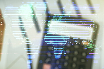 Double exposure of abstract digital world map on blurry calculator background, research and strategy concept