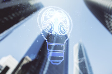 Abstract virtual creative light bulb with human brain hologram on blurry cityscape background, artificial Intelligence and neural networks concept. Multiexposure