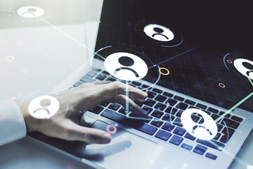 Double exposure of social network icons concept with hand typing on computer keyboard on background. Networking concept