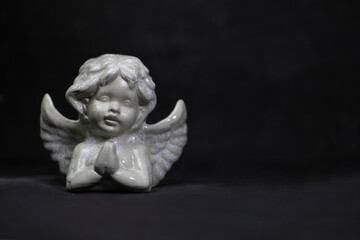 angel figurine on a black background