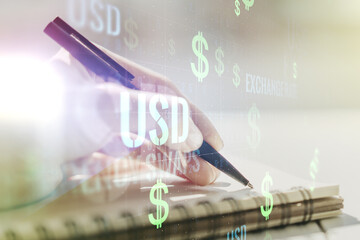 Creative concept of USD symbols illustration and woman hand writing in notebook on background. Trading and currency concept. Multiexposure