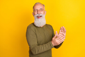 Photo of funny old grey beard man clap hands wear eyewear green sweater isolated on yellow color background