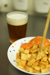 Patatas bravas traditional Spanish potatoes snack tapas with a beer