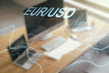 Double exposure of creative EURO USD forex chart hologram and modern desktop with laptop on background. Banking and investing concept