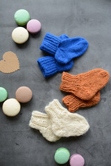Small woolen handmade baby socks, on gray background