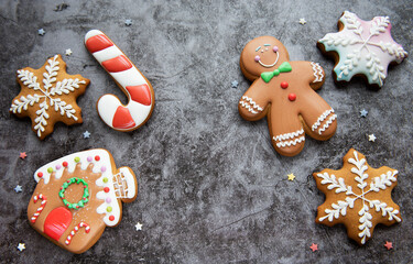 Christmas gingerbread cookies on black concrete background