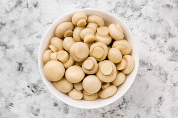 Pickled mushrooms - champignons in a bowl. Delicious mushrooms, champignon.