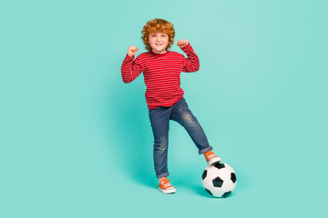 Full body photo of funny little boy play wear shirt jeans sneakers isolated on blue background