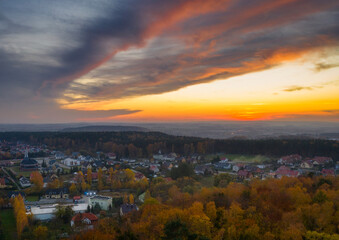 Beautiful sunset over the autumnal forest in Rotmanka, Poland