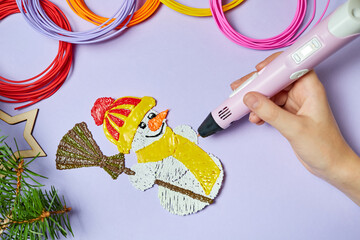 A girl is drawing a snowman Using a 3d pen on a purple background
