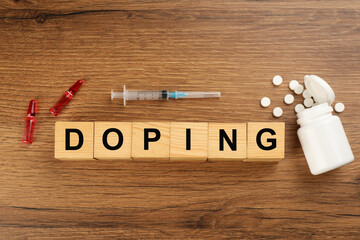 Cubes with word Doping and drugs on wooden background, flat lay