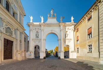 Fototapeta na wymiar Cherasco, Cuneo, Italy - October 27, 2021: Arch of Belvedere, ex voto for escaped the plague and the church of Sant Agostino (17th century designed by Giovenale Boetto) in via Vittorio Emanuele II