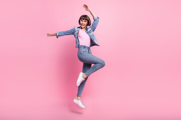 Full length body size view of attractive cheerful girl jumping dancing having fun rest isolated over pink pastel color background