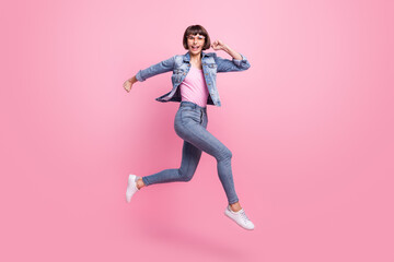 Fototapeta na wymiar Full length body size view of attractive cheerful girl jumping running isolated over pink pastel color background