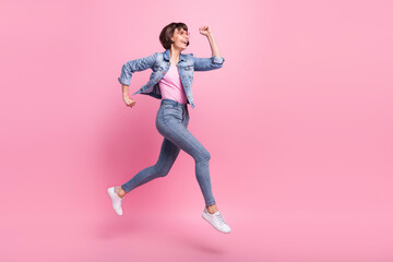 Fototapeta na wymiar Full length body size view of lovely cheerful girl jumping running motivation isolated over pink pastel color background