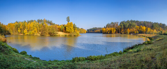 Panoramic view of lake and colorful trees in autumn landscape