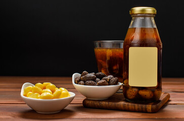 Delicious juice drink served by glass bottle on dessert table with bowl of clean organic ginkgo and Malva nut as raw ingredient mixing for healthy beverage